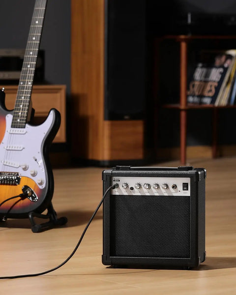 DEA 20W Electric Guitar Amp With Built In Reverb Clean And Overdrive Switch Treble And Bass EQ on wooden floor with guitar