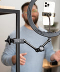Beefy Aluminum C Clamps With 1/4-20 And 3/8-16 Sockets holding a phone in a ring light on a desktop, 2 Pack Black
