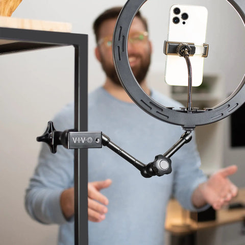 Beefy Aluminum C Clamps With 1/4-20 And 3/8-16 Sockets holding a phone in a ring light on a desktop, 2 Pack Black