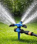 No Fuss Automatic Lawn Sprinkler System with 3 adjustable swivel arms and 12 nozzles in action on green grass.