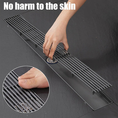 Sleek Linear Shower Drain With Locking Grate Cover For No Sweat Bathroom Floor Drainage And Anti Clog Hair Strainer Mesh Filter Effortless Cleanup Setup, being installed with hand placement.
