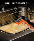 Person using Rechargeable Infrared Thermometer Gun For Cooking With Backlit Display And Go-To Digital Temp Tool For -58F To 1022F Range Perfect For Pizza Oven Grill Kitchen And Home Repairs With Max Hold over frying pan