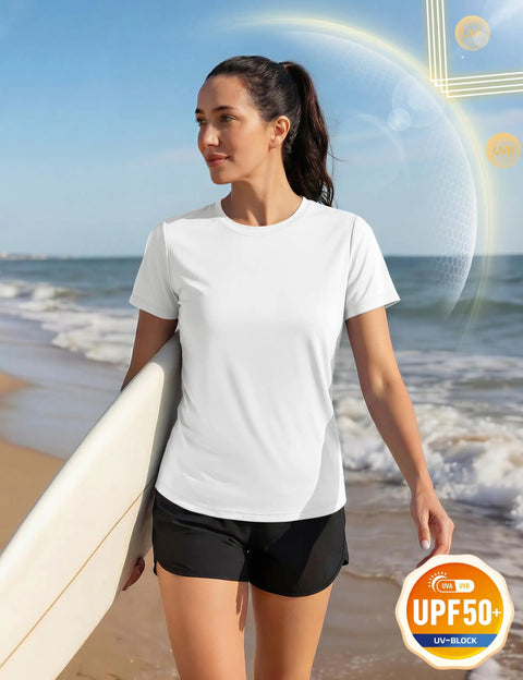 Woman on beach wearing Women's Short Sleeve Athletic Tee With UPF 50+ Sun Protection, Quick Dry Moisture-Wicking Workout Top, holding surfboard.
