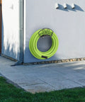 Go-To Garden Hose Holder Wall Mount Rack Holds 125 Feet Of Five Eighth Inch Hose mounted on outdoor wall with hose