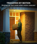 Man carrying package at night under Outdoor Motion Sensor Flood Light Bulbs for Driveways and Yards PAR38 3000K Soft White 1200 Lumen