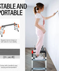 Boss Level Heavy Duty Aluminum Work Platform Folding Step Ladder With Non Slip Surface And Safety Lock Built To Last For Washing Cars Cleaning And Painting 45 Inch By 12 Inch By 27 Inch, woman painting wall