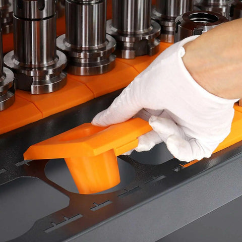 Close-up of a hand using an orange tool holder on Heavy Duty Industrial Steel Workbench With Pegboard And Lockable Drawers.