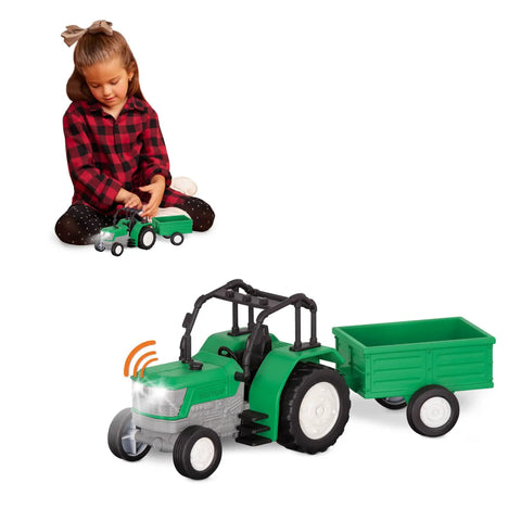 Child playing with 7-Inch Tractor Toy With Lights And Sounds, Movable Parts and Detachable Trailer with Rear Hatch on white background