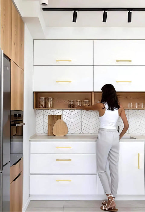 User reaching for glass jars in modern kitchen featuring 10 Pack Brushed Gold Cabinet Pulls and Drawer Handles 5 Inch Center to Center