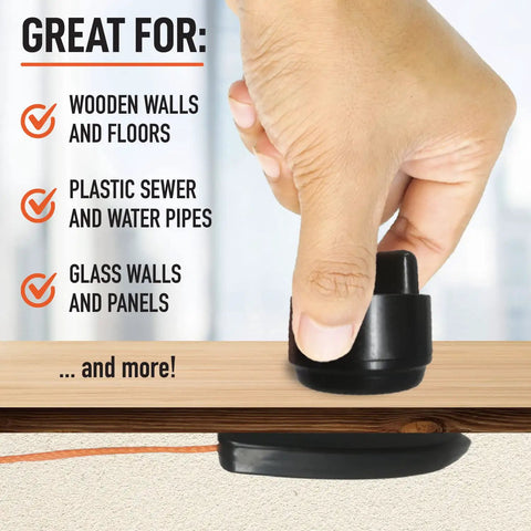 Hand using Wire Pulling System With Magnetic Tool Kit For Easy Cable Routing And Wall Installations on wooden surface.