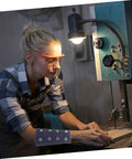 Woman using a saw wearing Slip On These Hella Tough Cut Resistant Arm Sleeves For Reliable Lightweight Wrist Guard Protection Built For Mechanic Jobs Welding And Outdoor Projects.