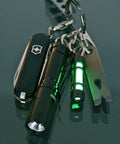 Keychain with Embrite Glow Fob With Green Embrite Pellet, Aircraft-Grade Aluminum Keychain Accessory For Everyday Carry in dark.