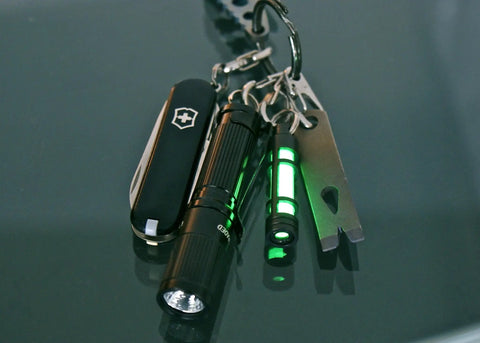 Keychain with Embrite Glow Fob With Green Embrite Pellet, Aircraft-Grade Aluminum Keychain Accessory For Everyday Carry in dark.