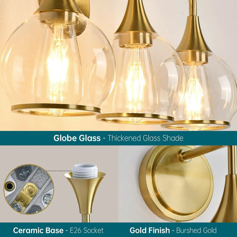 Close-up of gold three light vanity light over mirror with clear glass shades, 22.4 inch wall sconce bath fixture