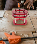 Sturdy Iron Router Lift Table Base With Red Finish For Small Electric Tenoning And Trimming Machines on wooden workspace.
