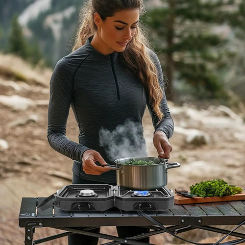 Woman cooking on Dual Burner Propane Camping Stove with Piezo Ignition in outdoor setting, showcasing stovetop use