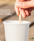 7 Inch Wood Coffee Stir Sticks 1000 Pack Eco Friendly Stirring Sticks For Lattes Cappuccinos Tea and Hot Chocolate shown in use with white paper cup