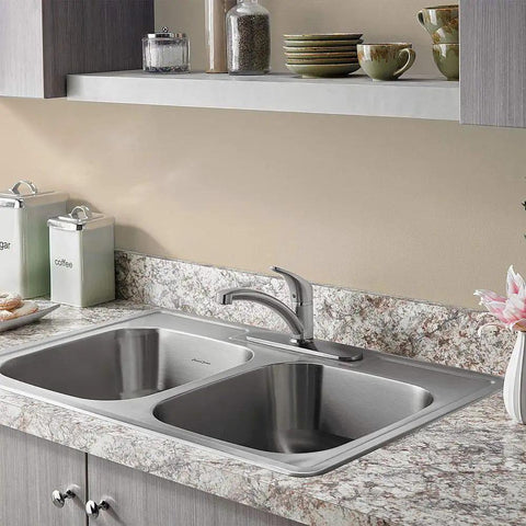 Colony Pro Single-Handle Kitchen Faucet With Deck Plate In Stainless Steel installed on a dual-basin kitchen sink