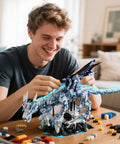 Person assembling Dark Ice Dragon Building Block Set With Hand Crank Motion Movable Head Wings And Limbs on table