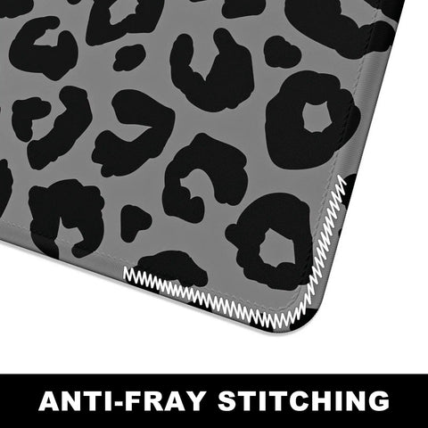 Close-up of Extended Gaming Desk Mat XXL Full Coverage Mouse Pad For Huge Desks Black Leopard Print with anti-fray stitching.