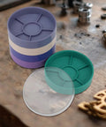 Round Watch Parts Tray with Stackable Layers and Portable Storage Case Built Tough with ABS on workshop table.