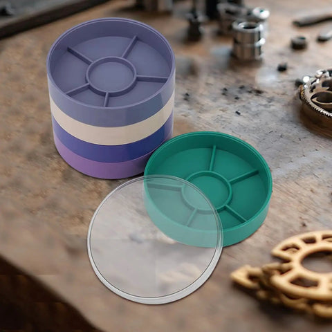 Round Watch Parts Tray with Stackable Layers and Portable Storage Case Built Tough with ABS on workshop table.