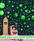 Child with cardboard rocket under Glow In The Dark Stars And Planets Ceiling Decals For Bedroom And Living Room Space Wall Stickers
