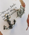 Antique Bronze Cabinet Knobs And Drawer Pulls Set with anchor and rudder nautical theme, shown close-up on paper background.