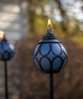 Two Pack Metal And Glass Globe Outdoor Torch Set For Patio And Yard Easy Install 64 Inch Tall Blue And Black With Wick And Snuffer in garden