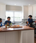 Family cooking in modern kitchen with VoiceIQ Activation Module for Touch2O Kitchen Faucets Compatible with Alexa and Google Assistant.