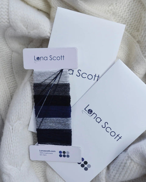 Super Handy Cashmere Darning Kit With 30 M Of High Grade Cashmere Thread In Six Colors displayed on white wool fabric.