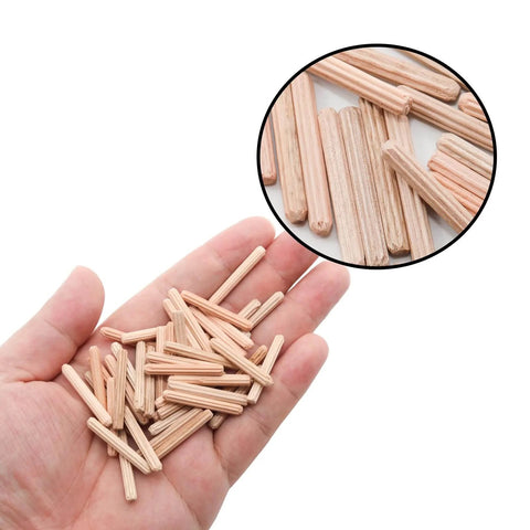 Hand holding Wooden Dowel Pin Set 48 Pcs, 4mm By 30mm And 5/32 Inch By 1.18 Inch, fluted beveled end pins for shelf support.