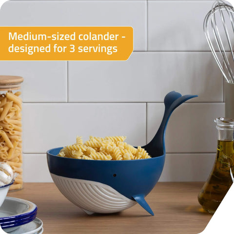 Pastail Medium Whale Shaped Pasta Colander For Draining Pasta Vegetables And Fruit filled with pasta, stands on fins for hands-free use