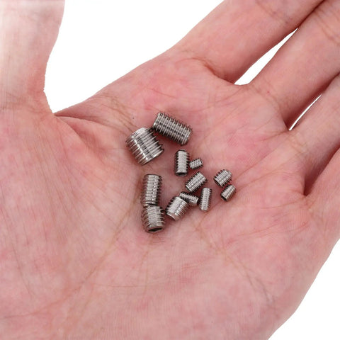 Hand holding screws from 240-Piece Stainless Steel Set Screws Kit With Internal Hex Socket Drive And Cup Point For Versatile Door Handles