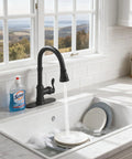 Matte Black Kitchen Sink Faucet With Pull Down Sprayer Three Outlet Modes in use, water flowing over dishes, farmhouse style sink