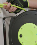 Close-up of Retractable 25 Ft Extension Cord Reel With 16/3 SJTOW Oil Resistant Cable being plugged into a wall outlet