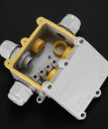 Outdoor Waterproof Junction Box 2 Pack Two Way Electrical Enclosure Transparent External Underground Cable Connector Box For 5mm 9mm 12mm 15mm Wires With Glands And Accessories Durable UV Resistant Dustproof. The image shows a grey rectangular junction box with multiple connectors and visible inner parts, designed for outdoor electrical connections.