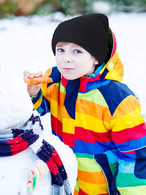 Child in colorful winter jacket next to snowman, not wearing Three Hole Full Face Balaclava Gaiter For Outdoor Sports And Cycling.