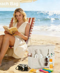 Woman reading on beach with Large 36L Waterproof Beach Tote Bag For Women With Zipper Wet Pocket Sandproof Lightweight Foldable Carryall Khaki White Stripes