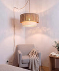 18 Inch Plug In Rattan Pendant Light With Premium Linen Shade Boho Ceiling Chandelier above a cozy chair in a softly lit room.