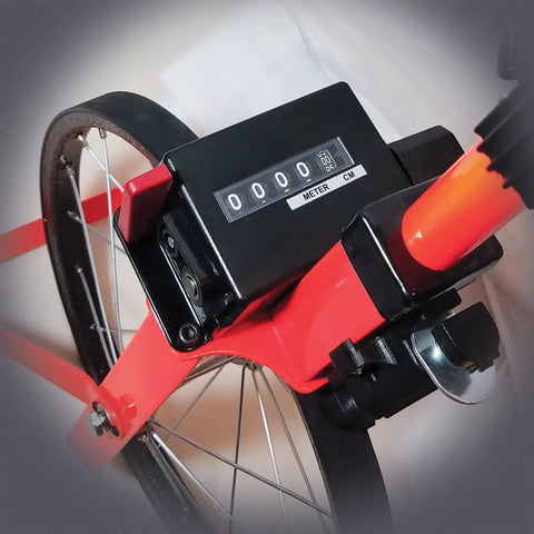 Close-up of the digital counter on the Top Tier Metric Measuring Wheel Featuring A Smooth Belt Driven Counter And Heavy Duty Rubber Tire For Rock Solid Linear Measurements On Rough Job Sites Compact Fluorescent Red Build.