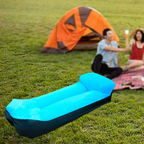Inflatable Lounger Camping Couch For Adults And Kids, Air Sofa Chair in blue, set on grass near a tent and a picnic setup.