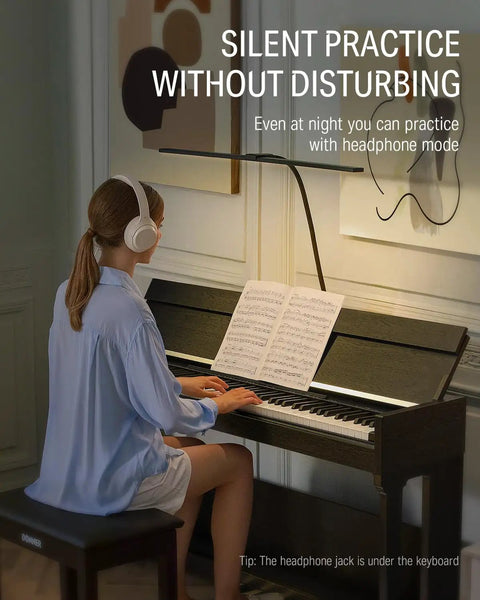 Woman playing DDP-90 Pro 88 Key Weighted Digital Piano with headphones, sheet music open, in living room setting