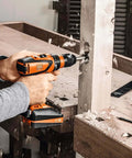 Battle Ready Heavy Duty Cordless Drill Driver Featuring Four Speed Rugged Metal Gearbox Brushless Motor Maximum Torque Output For Wood Metal Plastic Projects drilling into wood workbench.