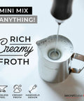 Handheld USB C Rechargeable Milk Frother With 3 Speed Settings and Stainless Steel Double Whisk creating froth in metal pitcher
