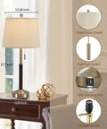 Lamp with cream shade and pull chain on brown wood stand with USB port on nightstand.