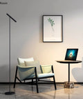 Tall LED Floor Lamp With Foot Switch 66 Inch Modern standing lamp illuminating a cozy office with chair and laptop on desk