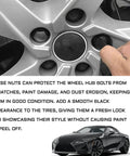 Close-up of 20 Piece Black Lug Nut Covers 21Mm Hexagonal Wheel Center Bolt Caps on silver rim protecting bolts from damage.
