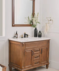 Widespread 8 Inch Bathroom Faucet In Black And Gold, 3 Hole Sink Mixer With Two Handles on wooden vanity in bathroom setting.
