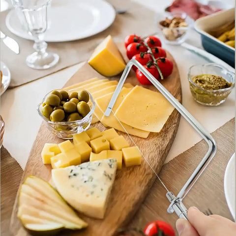 Six Inch Stainless Steel Cheese Slicer Handheld Wire Cutter cutting smooth slices of cheese on a wooden charcuterie board.